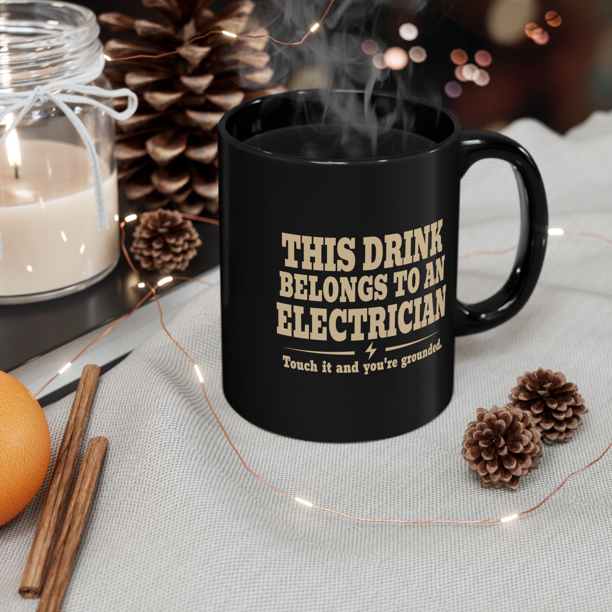 Black electrician mug shown in a styled coffee setting