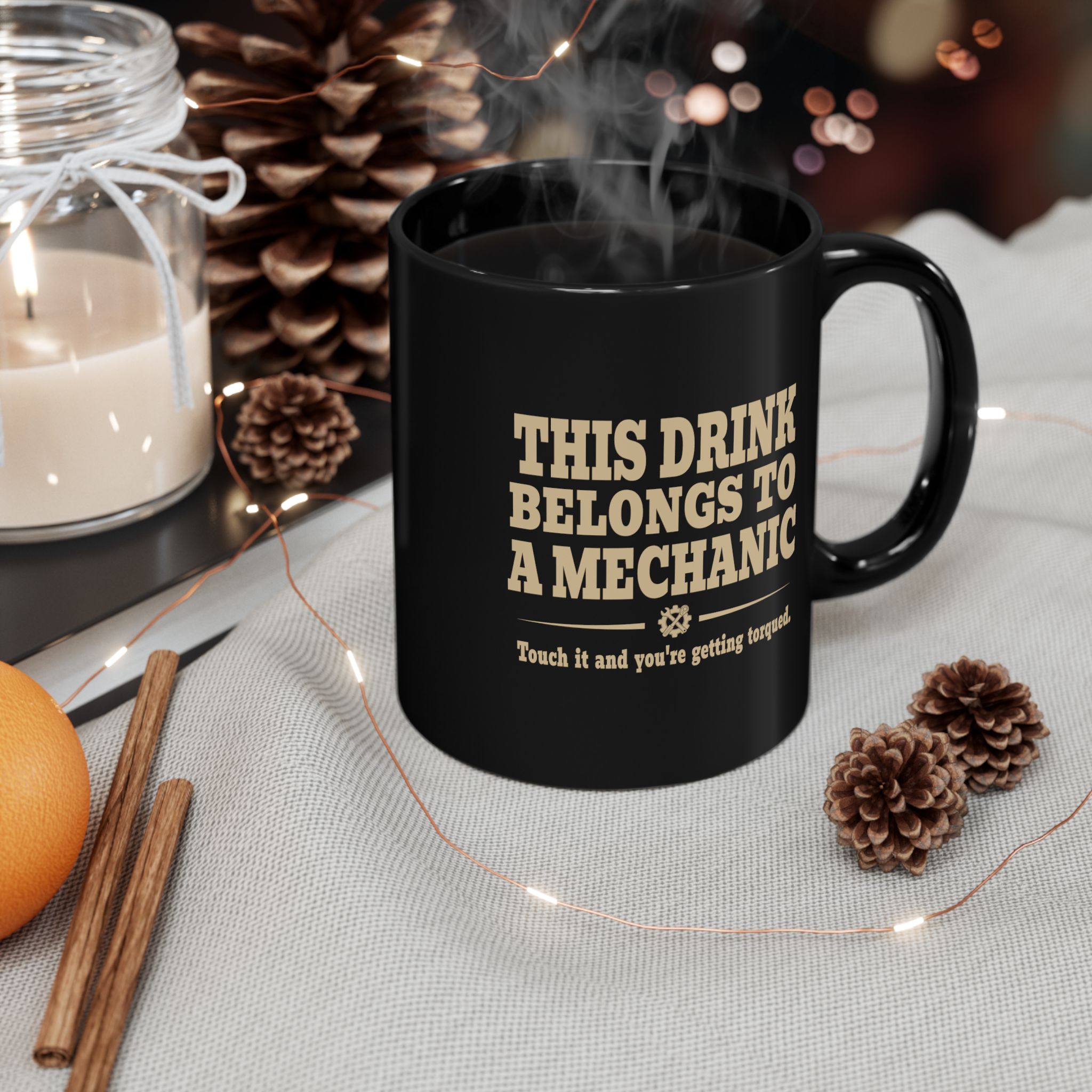 Black mechanic mug shown in a styled coffee setting